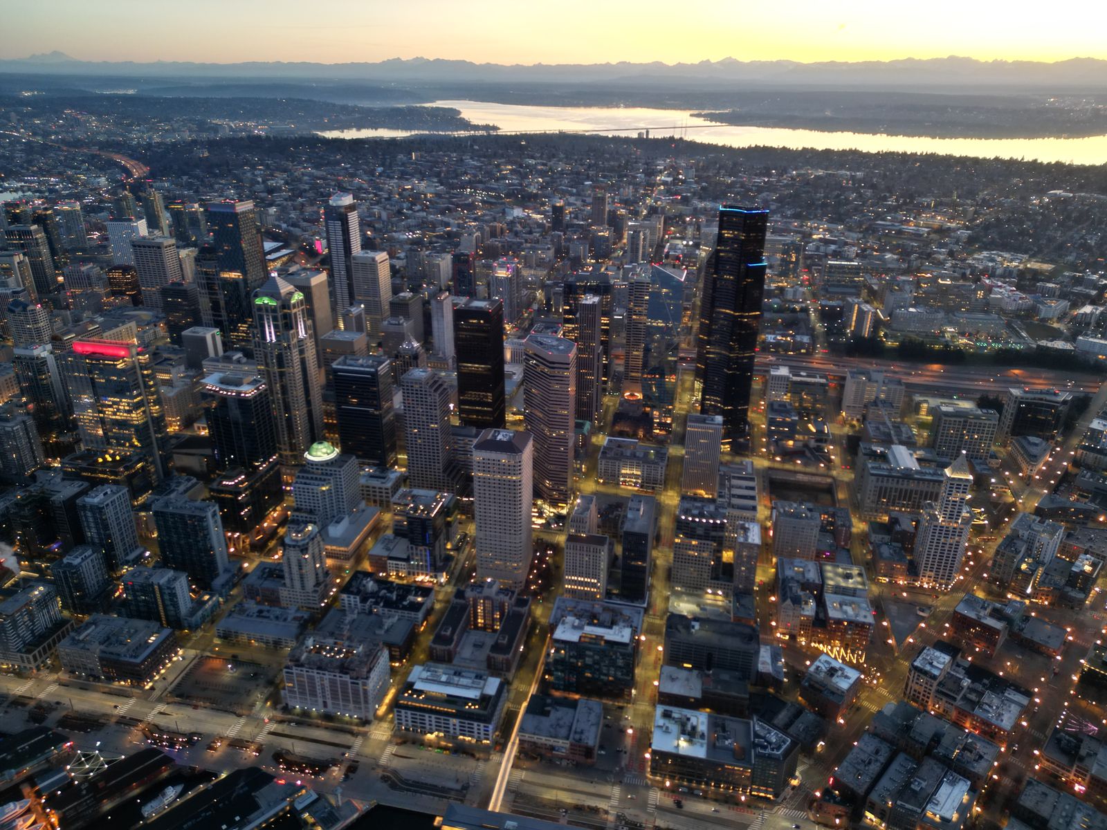 Aerial photograph of downtown Seattle at first light, the street grid still glowing