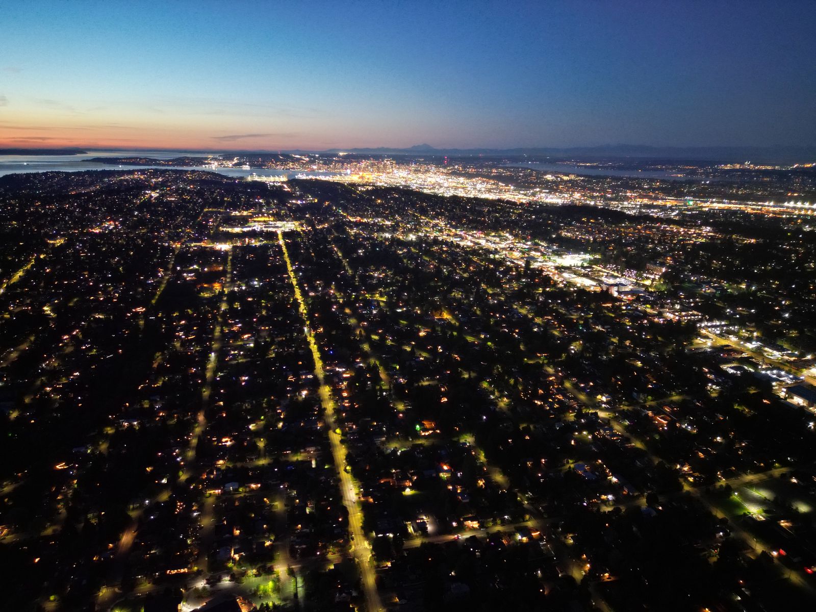 Aerial night photograph of lit street grids stretching across South King County