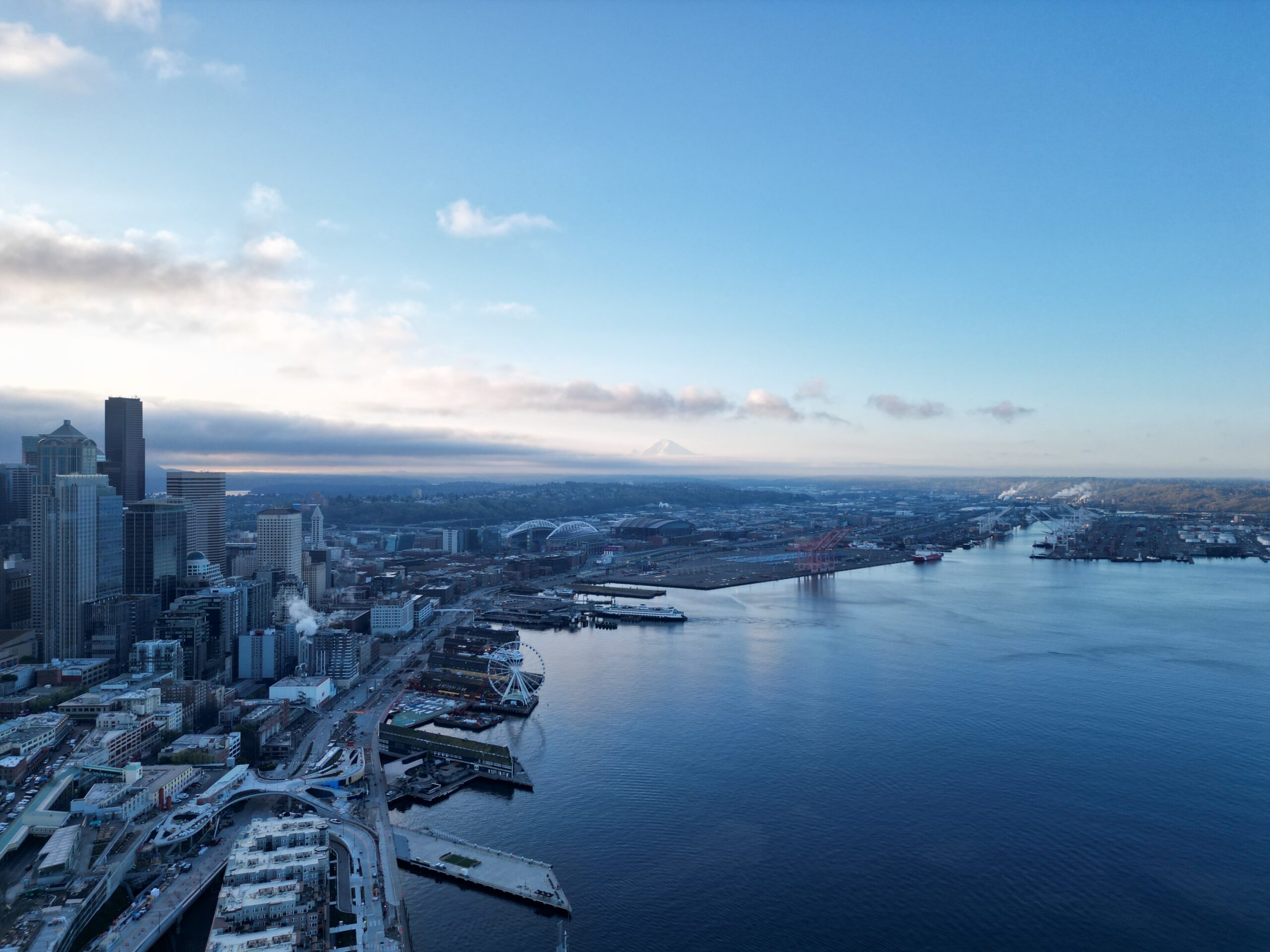 Seattle skyline with ferry crossing Elliott Bay and Cascade Mountains